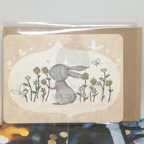 Rabbit Loving Flowers Greeting Card